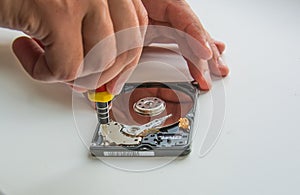 Two man hands fixing harddisc using screwdriver, close-up