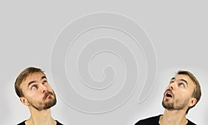 Two man heads portrait with different emotions and face grimace, looking up, gray background, copy space