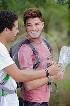 two man hikers looking at map