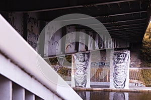 Two man holding bridge graffiti in Vilnius