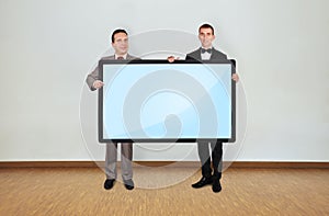 Two man holding plasma