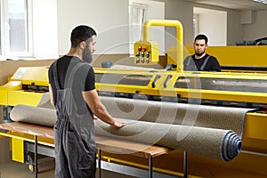 Two man operating professional cleaning equipment in laundry service cleaning carpet