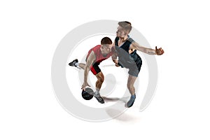 Two man, professional basketball players in motion, playing with ball, training isolated against white background