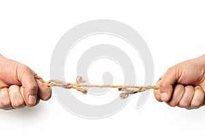 Two man are pulling old frayed rope in opposite direction with strength. Isolated on white. Compotetion in business