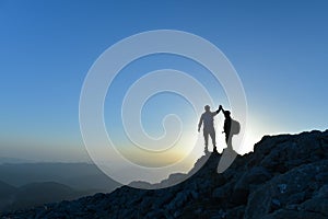 Two man with success gesture on mountain