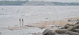 Two man walk when Small ocean waves breaking on beach