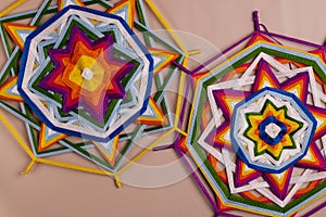 Two mandalas made of colored threads.