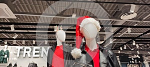 Two mannequins in a clothing store at Christmas, decorated mannequins for new year. A mannequin in a Christmas New Year