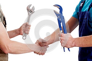 Two manual workers shaking their hands