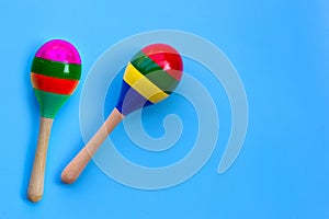 Two maracas on blue background