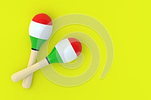 Two maracas on yellow background. Flat lay. Copy space