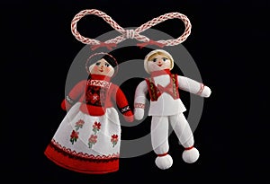 two martenitsa dolls in traditional russian clothing are hanging from a rope