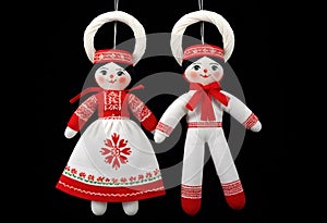 two martenitsa dolls in traditional russian clothing hanging from a string