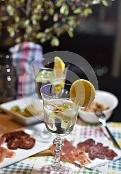 Two martinis with lemon and ice slice