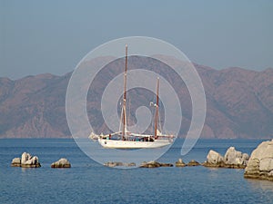 Two-masted schooner sails along the coast