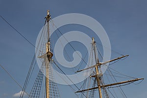 Two masts, rigging and shrouds on an old tall ship against a blue sky