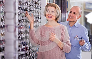 Two mature customers in glasses store