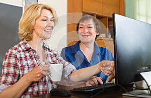 Two mature female browsing web