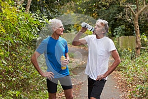 Two Mature Male Joggers Taking Break Whilst On Run photo