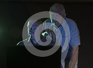 Two mature men looking at a computer screen