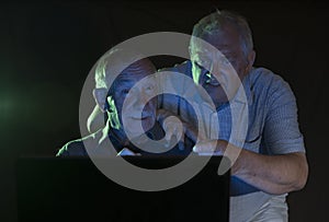 Two mature men looking at a computer screen