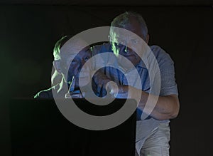 Two mature men looking at a computer screen