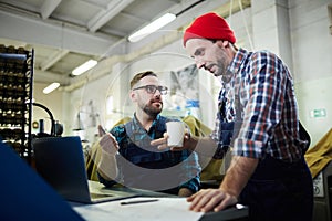 Two Mature Men Working at Factory