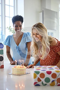 Two Mature Women Meeting At Home To Celebrate Friend\'s Birthday With Surprise Cake Together