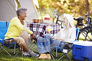 Two Mature Women Relaxing On Camping Holiday