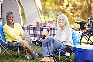 Two Mature Women Relaxing On Camping Holiday