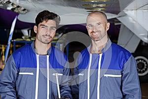 Two mechanics working on aircraft