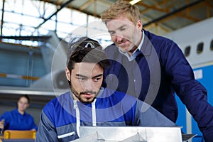 two mechanics working on aircraft