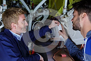 two mechanics working on aircraft