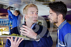 two mechanics working on aircraft