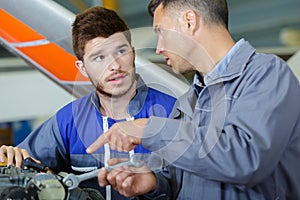 two mechanics working on airplane