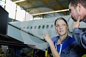 two mechanics working on aircraft