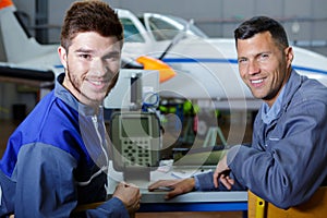 two mechanics working on aircraft