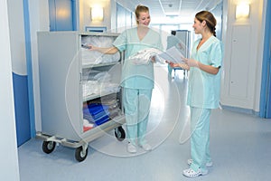 Two medical professionals talking in hallway