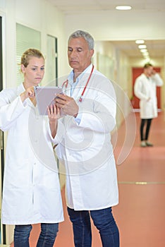 Two medics conferring in corridor photo