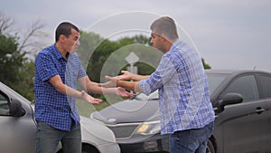 Two men arguing conflict after a car accident on the road car insurance. slow motion video. Two Drivers man Arguing