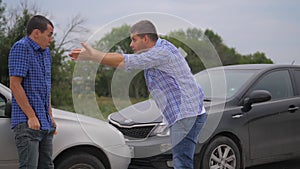 Two men arguing conflict after a car accident on the road car insurance. slow motion video. Two Drivers man Arguing