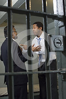 Two Men Arguing In Prison Cell