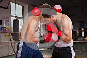 Two men is boxing on the ring