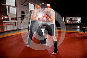 Two men is boxing on the ring