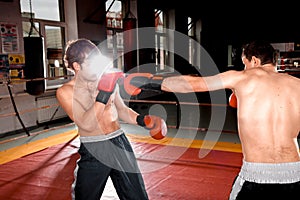 Two men is boxing on the ring