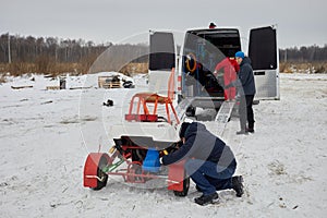 Two men and boy outdoor on winter day prepare photo