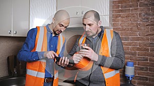 Two men builders communicate during coffee breaks.