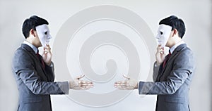 Two men in business suit handshaking with masks on - Business fraud and hypocrite agreement photo