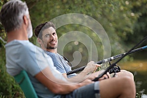 two men on camping holiday with fishing rod