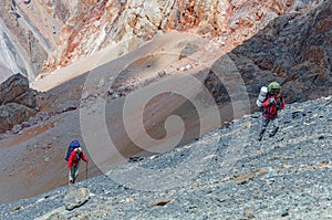 Two men climbing on the top.